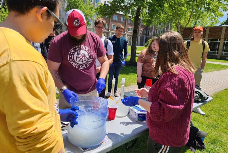 Chemistry Club members mix a batch of slime for students to throw at faculty